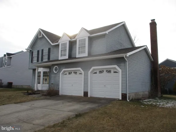 a view of a house with large space and a garage