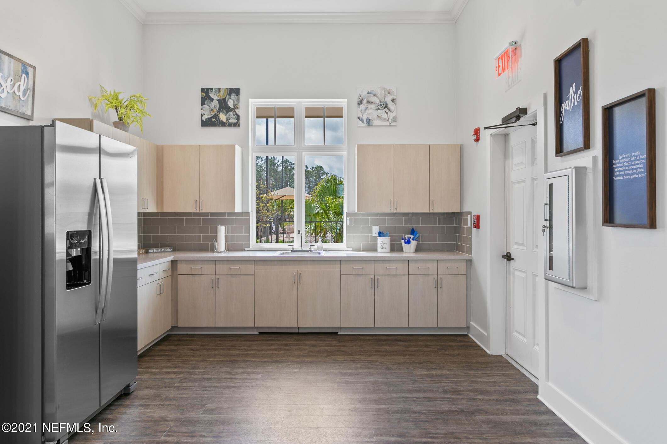 1360 Parkland Trail St. Augustine, FL 32095 - Photo 24 of 37 a kitchen with stainless steel appliances a refrigerator sink and white cabinets