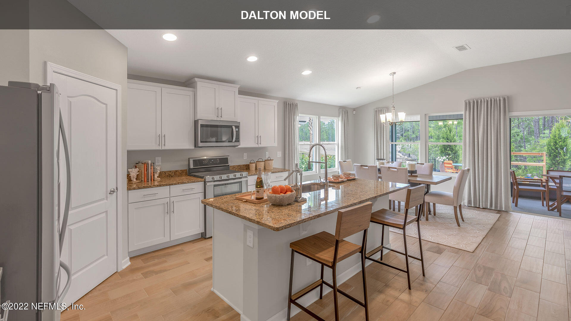 1360 Parkland Trail St. Augustine, FL 32095 - Photo 6 of 37 a kitchen with stainless steel appliances granite countertop a stove a refrigerator a kitchen island a table and chairs