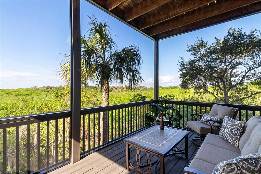 7325 Holly Road Terra Ceia, FL 34250 - Photo 31 of 87 a balcony with furniture and a potted plant
