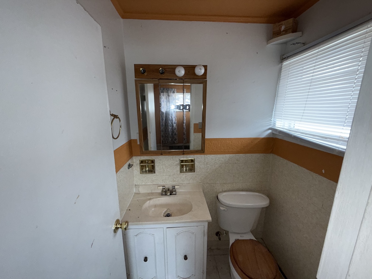 202 Wilson Street Park Forest, IL 60466 - Photo 9 of 9 a bathroom with a toilet sink and mirror