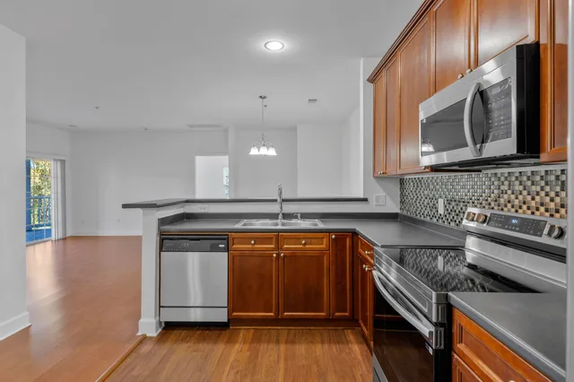 a kitchen with wooden cabinets and a stove top oven