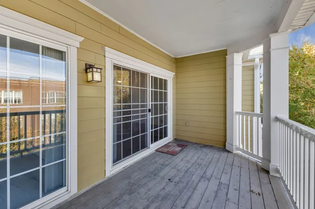 a view of a room with wooden floor and windows