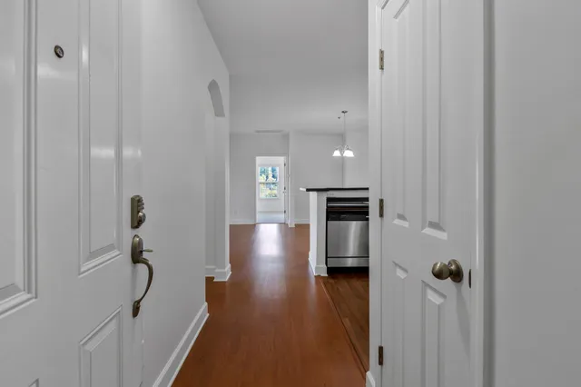 a view of hallway with wooden floor