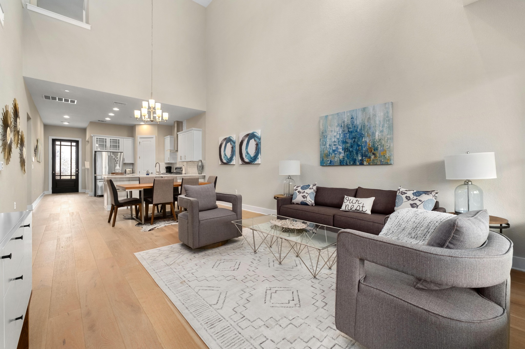 4323 Spicewood Springs Road, Unit 2 Austin, TX 78759 - Photo 7 of 30 Living area with light wood-type flooring, a chandelier, and a high ceiling