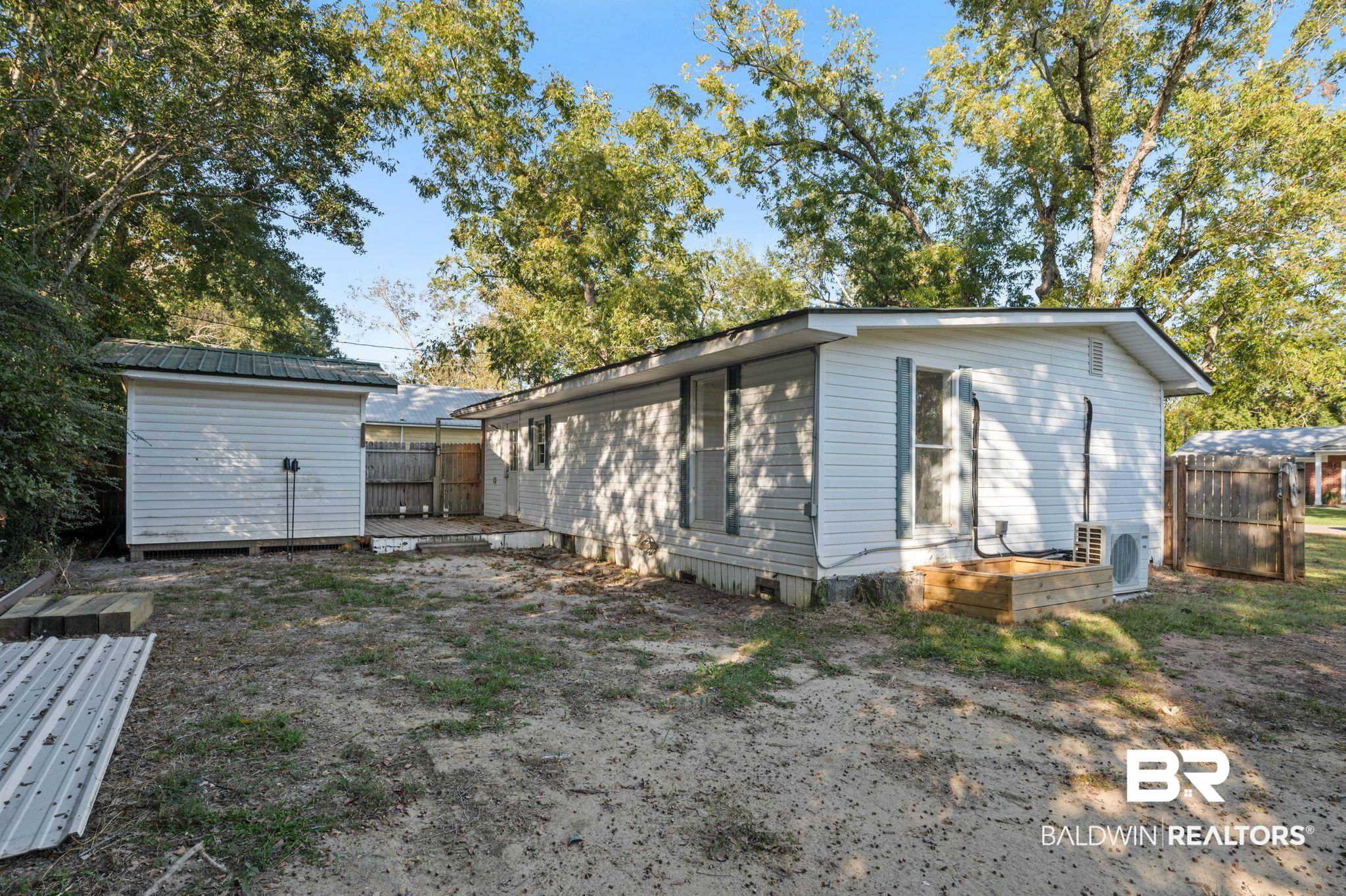 503 North Holly Street Foley, AL 36535 - Photo 18 of 23 Back of house featuring ac unit and a shed