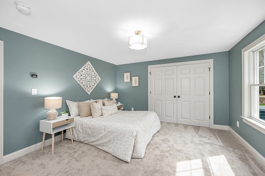 29 Washington Street Boxford, MA 01921 - Photo 15 of 39 a bedroom with a bed and a chandelier