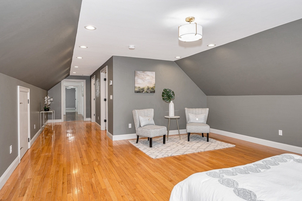 29 Washington Street Boxford, MA 01921 - Photo 19 of 39 a spacious bedroom with a bed and a chandelier