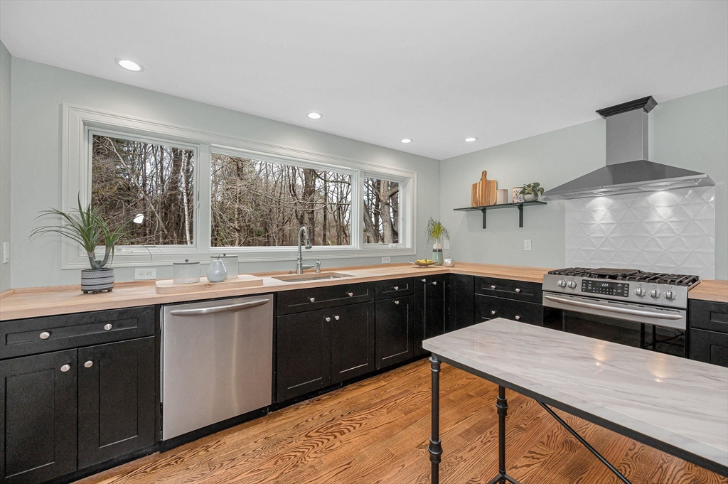 29 Washington Street Boxford, MA 01921 - Photo 9 of 39 a kitchen with a sink stove and cabinets