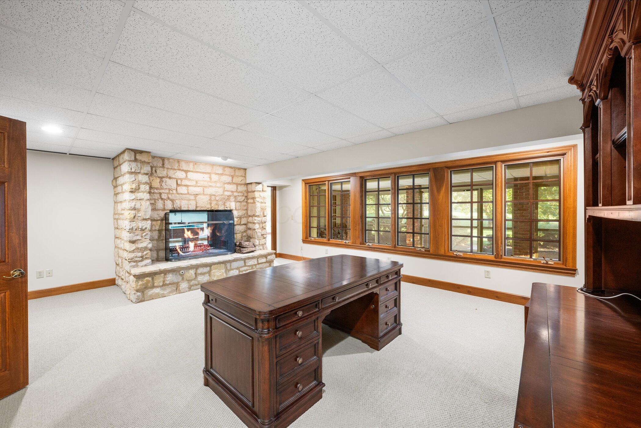18261 Boerger Road Marysville, OH 43040 - Photo 69 of 94 Basement office shares 2-sided fireplace. This room has lots of windows and 2 entrances.