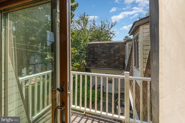 a bedroom with a bed next to a window