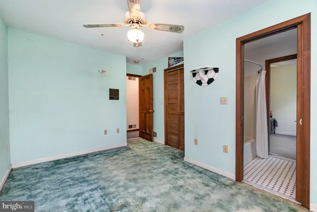 a bathroom with a granite countertop sink a toilet and a shower