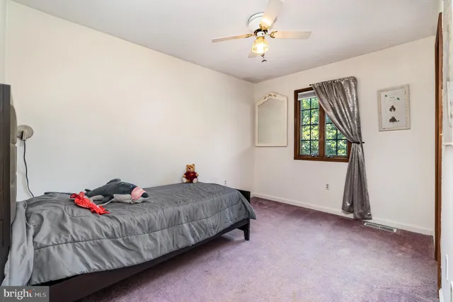 a view of a hallway to a livingroom with furniture