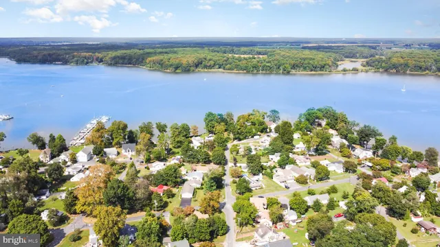 an aerial view of a houses with a lake view