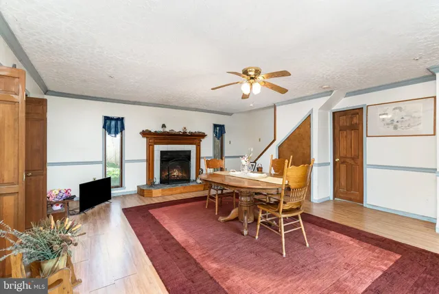 a living room with furniture a fireplace and a table