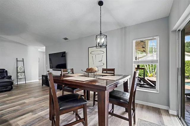a view of a dining room with furniture window and wooden floor