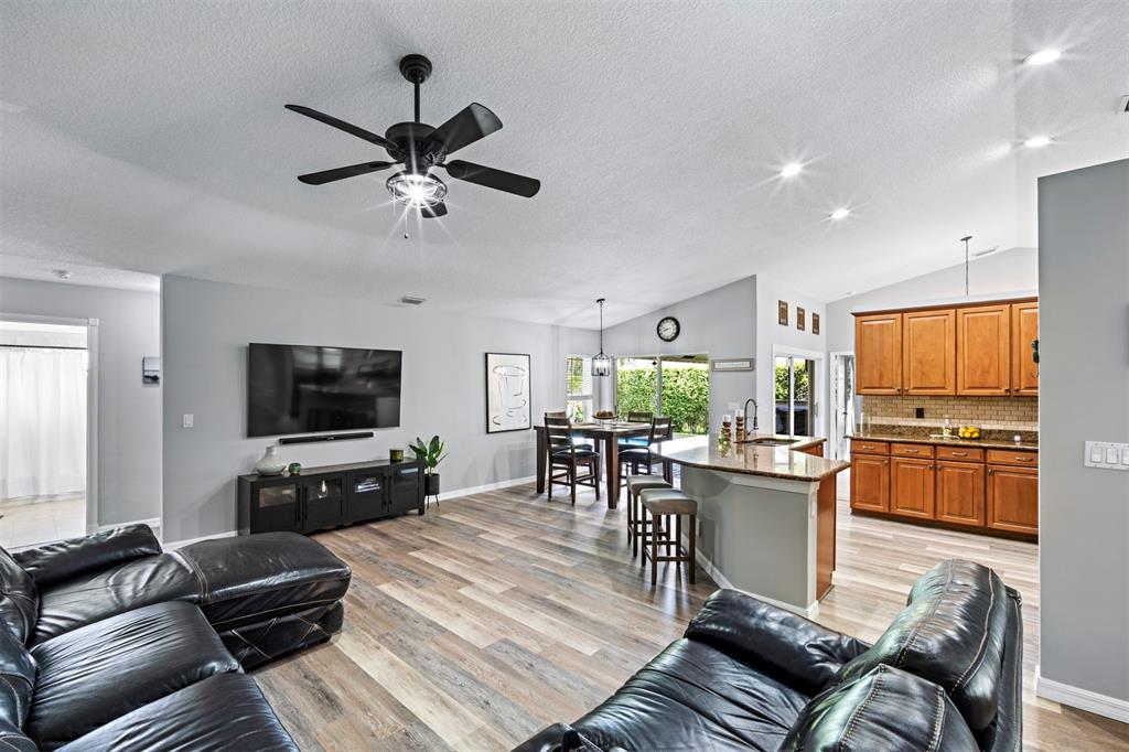 5133 Northwest 47th Avenue Coconut Creek, FL 33073 - Photo 14 of 44 a living room with furniture and a flat screen tv