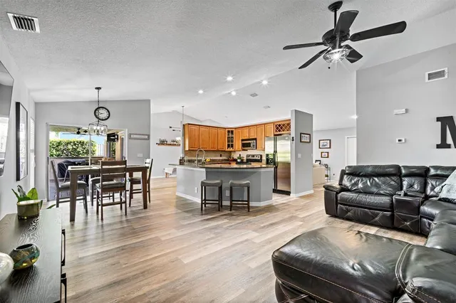 a living room with furniture and kitchen view