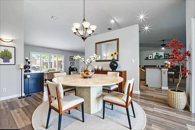 a view of a dining room with furniture and wooden floor