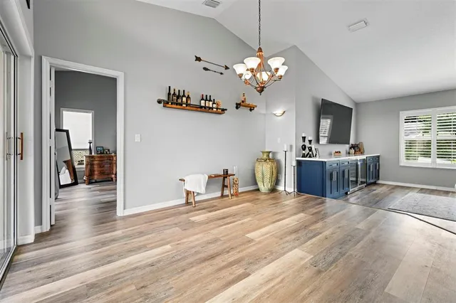 a view of a room with kitchen island chandelier and wooden floor