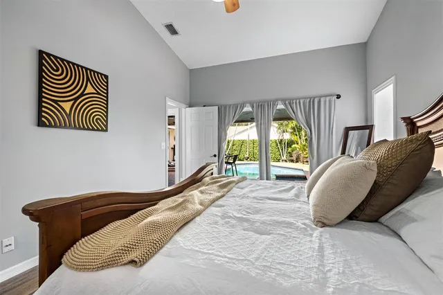 a bedroom with a bed and a painting on the wall