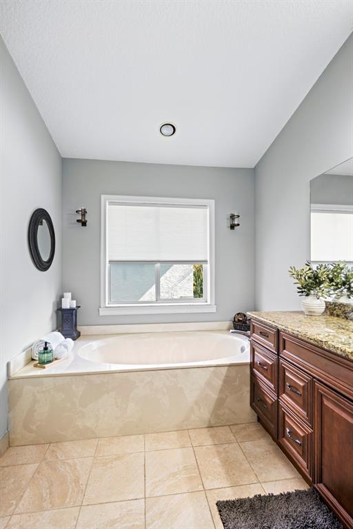 5133 Northwest 47th Avenue Coconut Creek, FL 33073 - Photo 27 of 44 a bathroom with a tub sink and mirror
