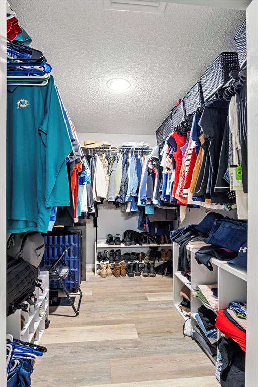 5133 Northwest 47th Avenue Coconut Creek, FL 33073 - Photo 28 of 44 a view of walk in closet with clothes and shoes