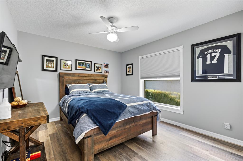 5133 Northwest 47th Avenue Coconut Creek, FL 33073 - Photo 29 of 44 a bedroom with a bed and wooden floor