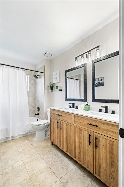 5133 Northwest 47th Avenue Coconut Creek, FL 33073 - Photo 30 of 44 a spacious bathroom with a double vanity sink mirror and toilet