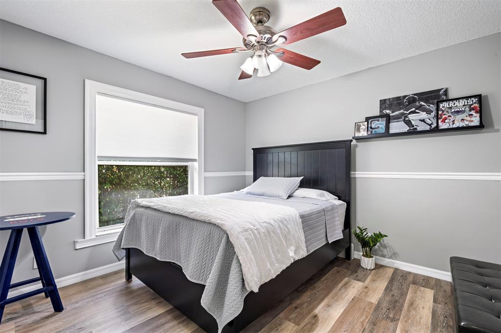 5133 Northwest 47th Avenue Coconut Creek, FL 33073 - Photo 31 of 44 a bed sitting in a bedroom next to a window