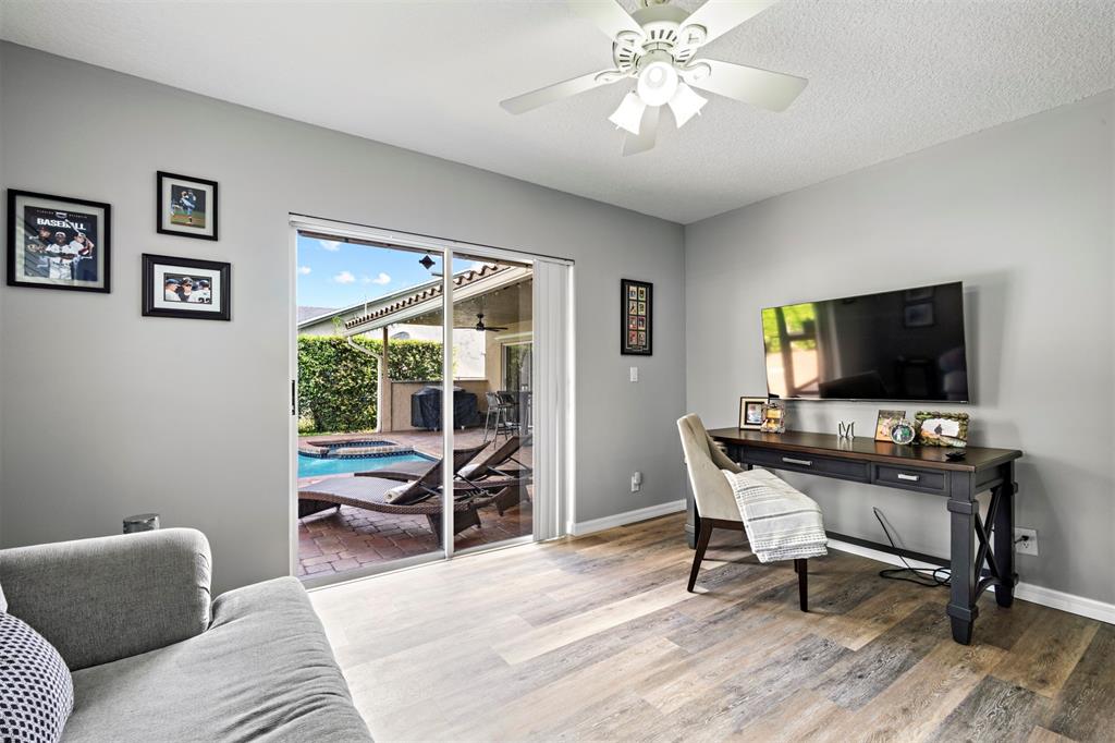 5133 Northwest 47th Avenue Coconut Creek, FL 33073 - Photo 33 of 44 a view of a livingroom with furniture and a flat screen tv
