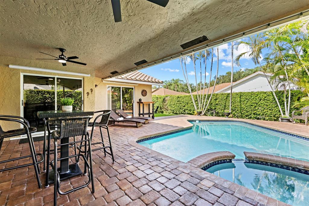 5133 Northwest 47th Avenue Coconut Creek, FL 33073 - Photo 36 of 44 a outdoor space with a patio and outdoor seating