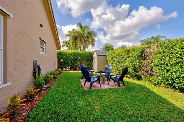a backyard of a house with table and chairs