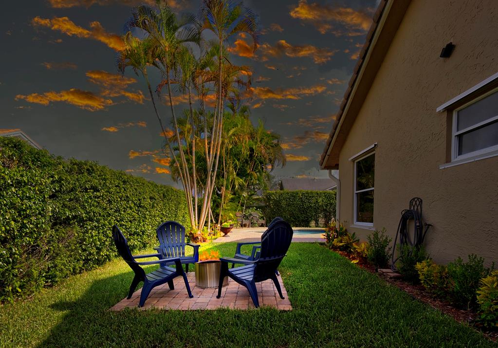 5133 Northwest 47th Avenue Coconut Creek, FL 33073 - Photo 41 of 44 a backyard of a house with table and chairs