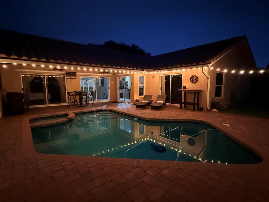 5133 Northwest 47th Avenue Coconut Creek, FL 33073 - Photo 43 of 44 a view of a house with swimming pool and sitting area