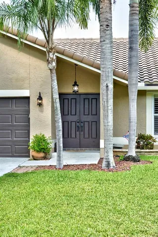 a view of a house with a yard and plants