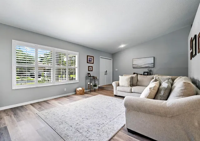 a bed room with a bed a couch and a large window