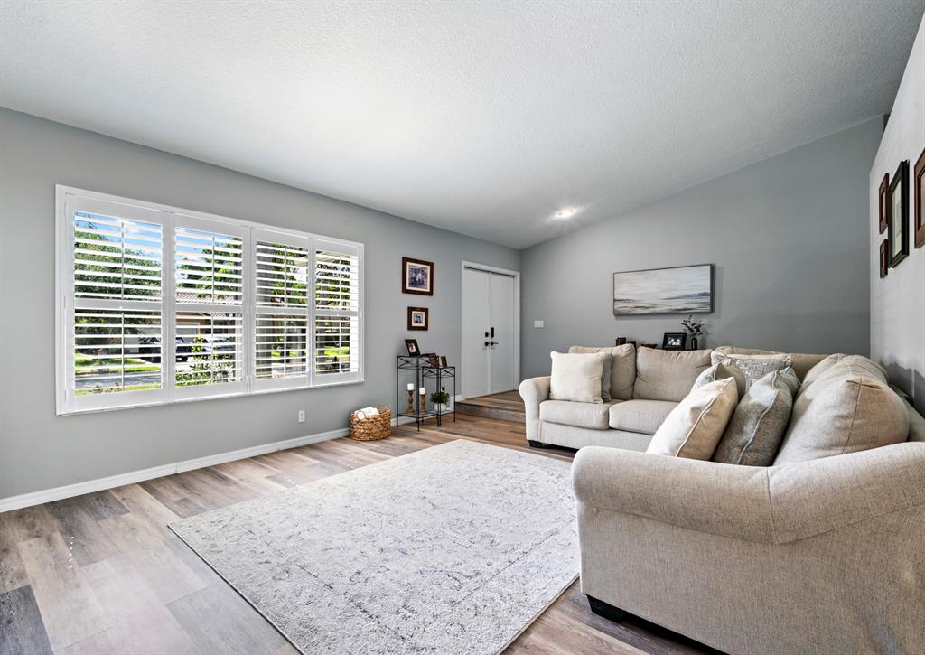 5133 Northwest 47th Avenue Coconut Creek, FL 33073 - Photo 7 of 44 a bed room with a bed a couch and a large window