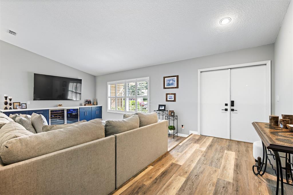 5133 Northwest 47th Avenue Coconut Creek, FL 33073 - Photo 8 of 44 a living room with furniture and a flat screen tv