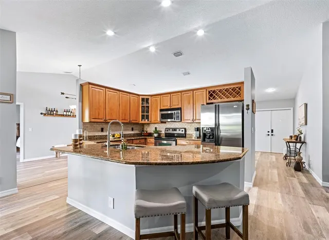 a large kitchen with a table and chairs