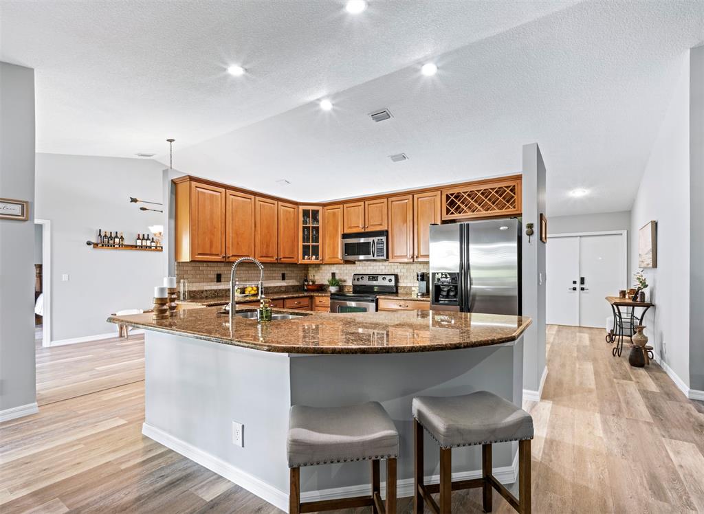 5133 Northwest 47th Avenue Coconut Creek, FL 33073 - Photo 9 of 44 a large kitchen with a table and chairs