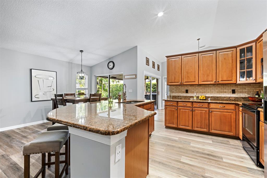 5133 Northwest 47th Avenue Coconut Creek, FL 33073 - Photo 10 of 44 a kitchen with granite countertop a sink appliances and cabinets