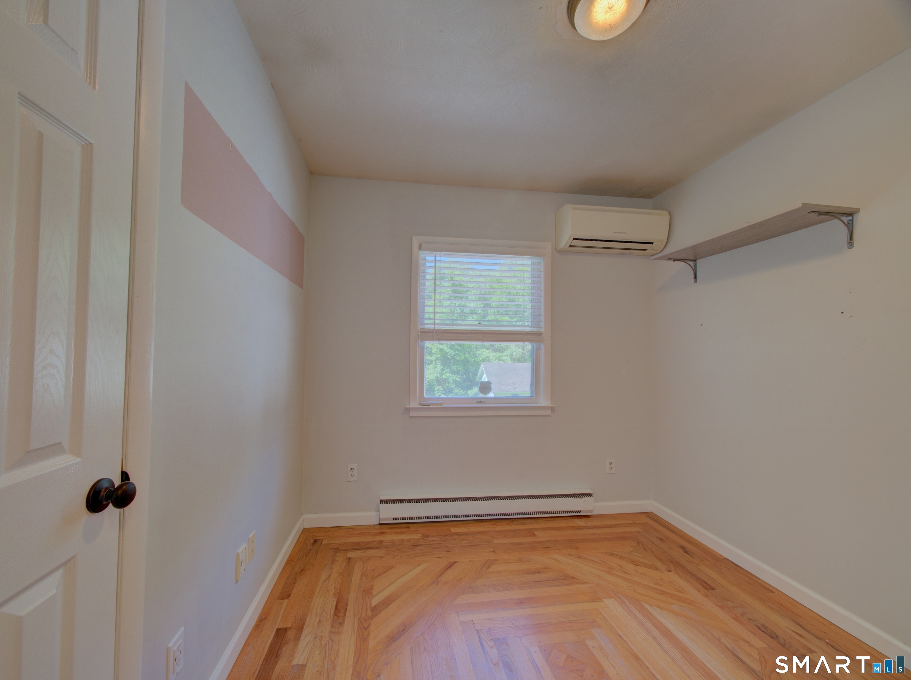 311 Sandy Hollow Road Groton, CT 06355 - Photo 9 of 26 a view of a room with rack on the wall and a window