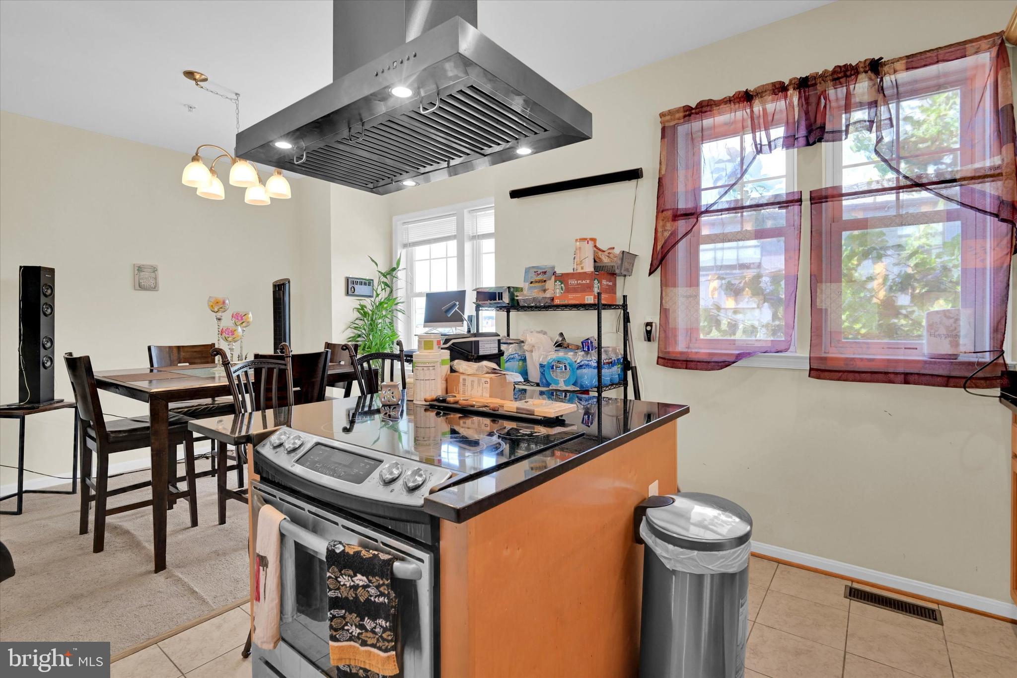 2380 Elvans Road Southeast Washington, DC 20020 - Photo 12 of 27 a kitchen with stainless steel appliances granite countertop a stove a refrigerator and a dining table