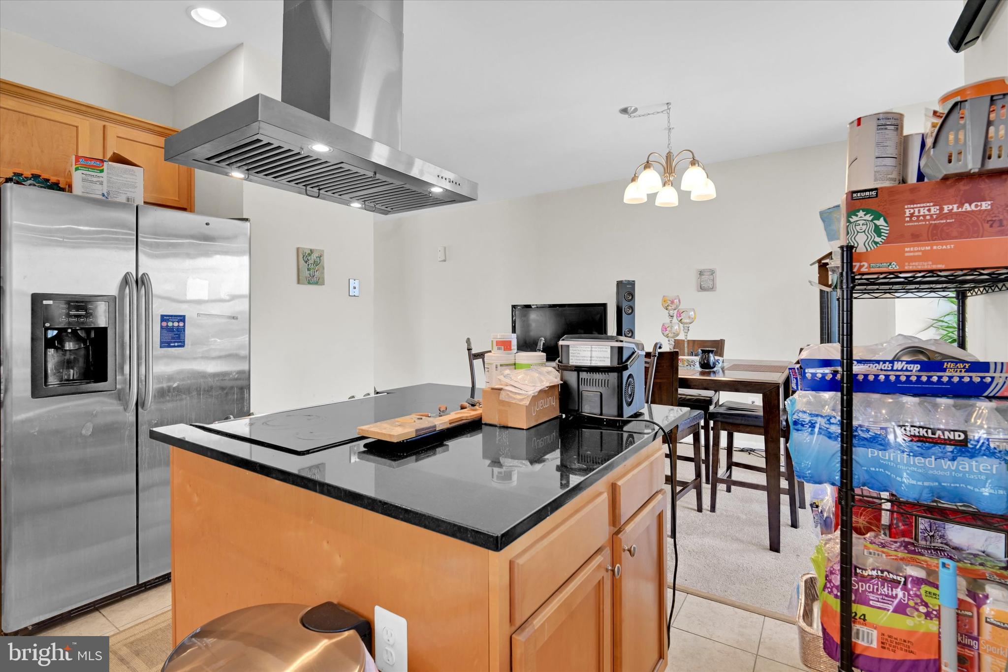 2380 Elvans Road Southeast Washington, DC 20020 - Photo 13 of 27 a kitchen with stainless steel appliances granite countertop a table chairs and a refrigerator