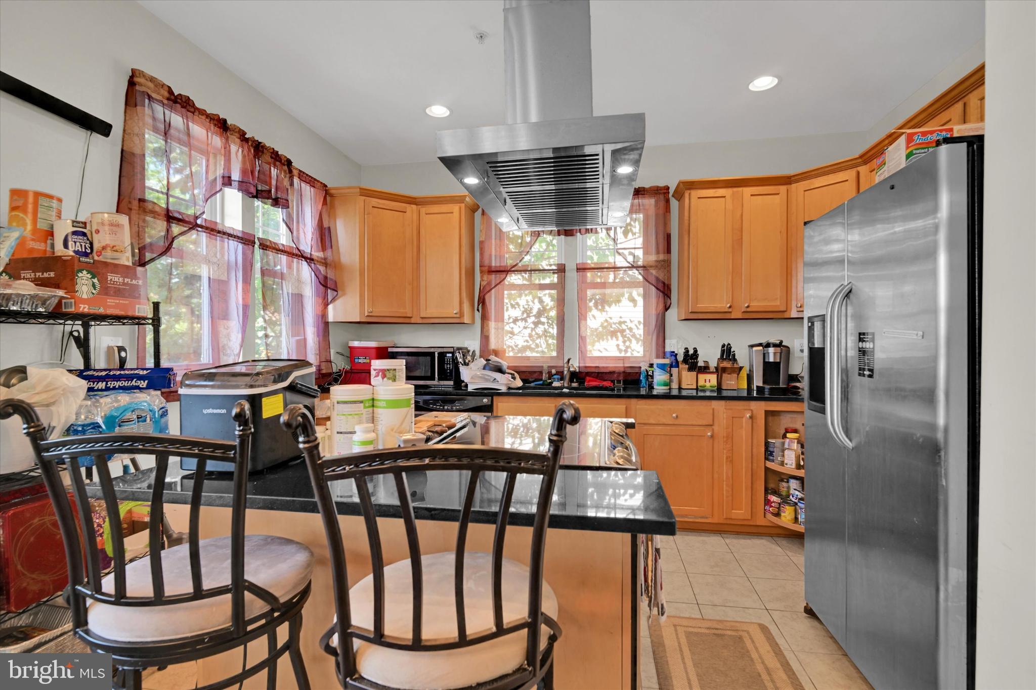 2380 Elvans Road Southeast Washington, DC 20020 - Photo 10 of 27 a kitchen with stainless steel appliances granite countertop a refrigerator a stove and a dining table with wooden floor