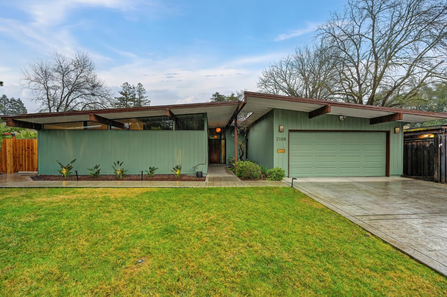 a view of a backyard with a garden and entertaining space