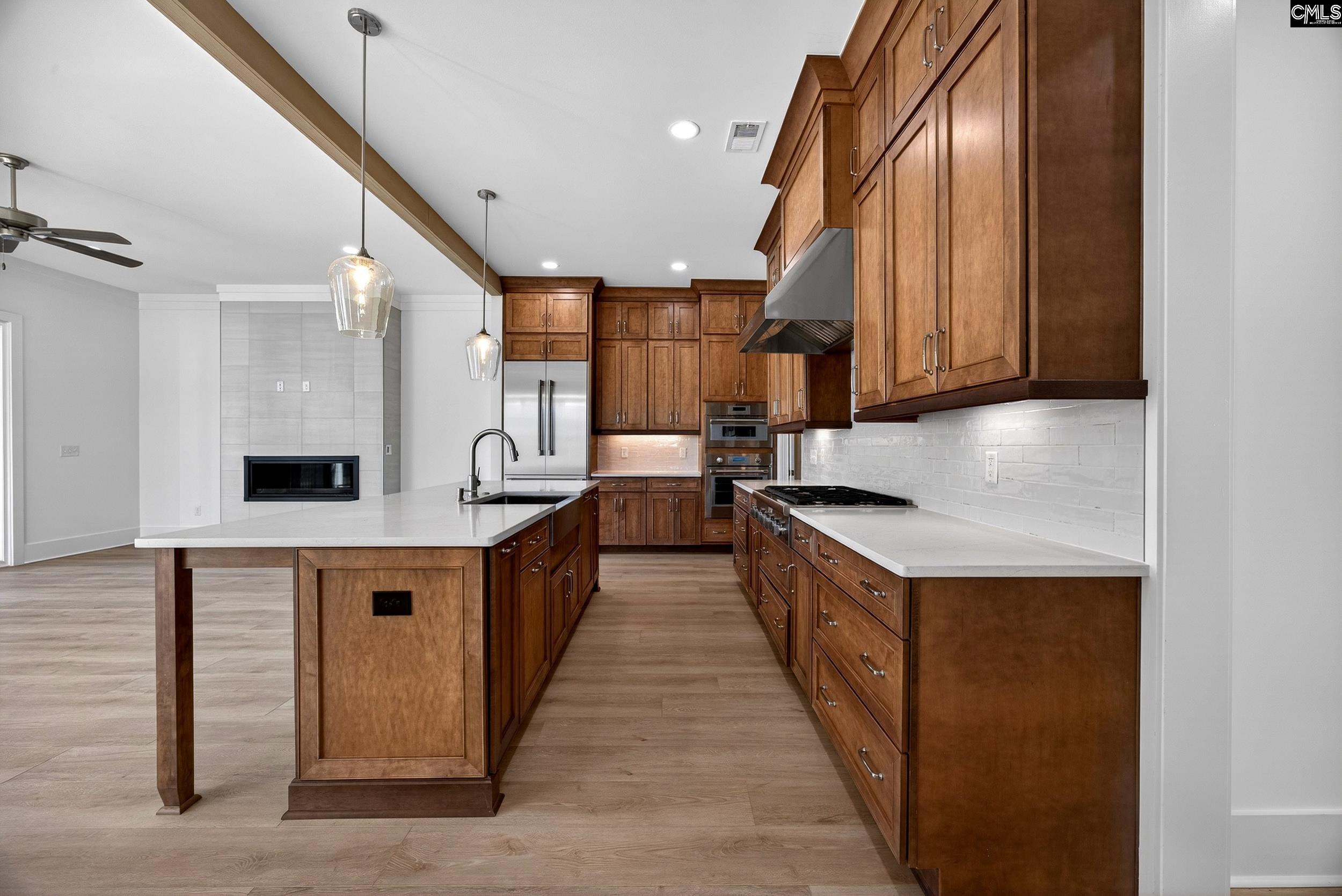 1318 Long Grove Way Lexington, SC 29072 - Photo 7 of 90 a kitchen with stainless steel appliances granite countertop a sink a stove and a wooden floors