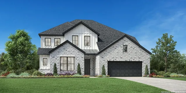 a front view of a house with a garden and yard