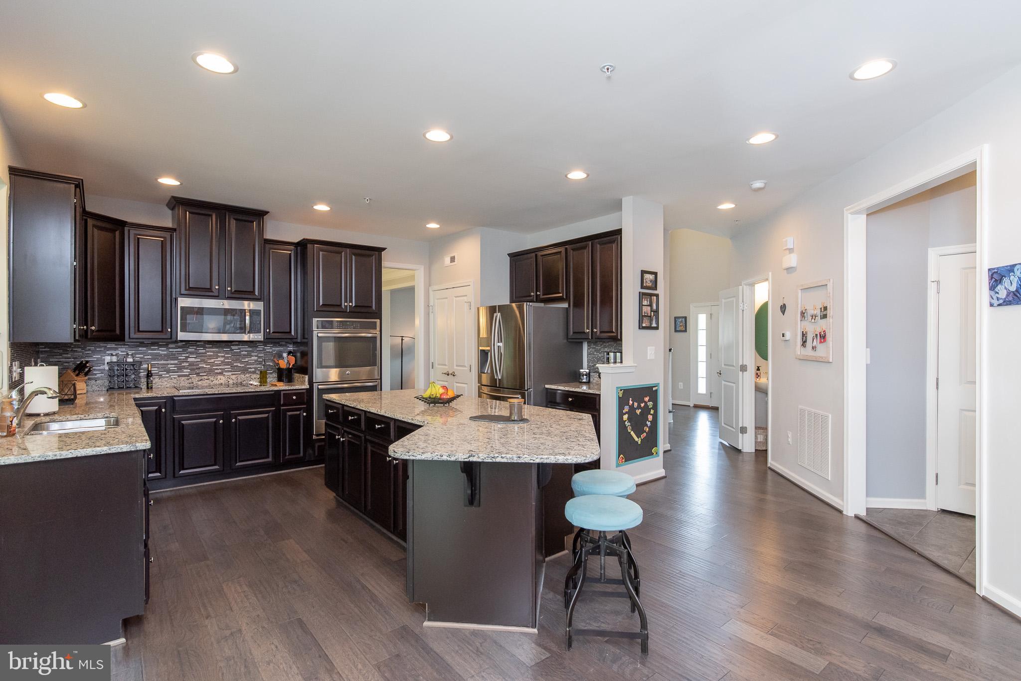 10426 Windlass Run Road Baltimore, MD 21220 - Photo 12 of 56 a large kitchen with a table and chairs